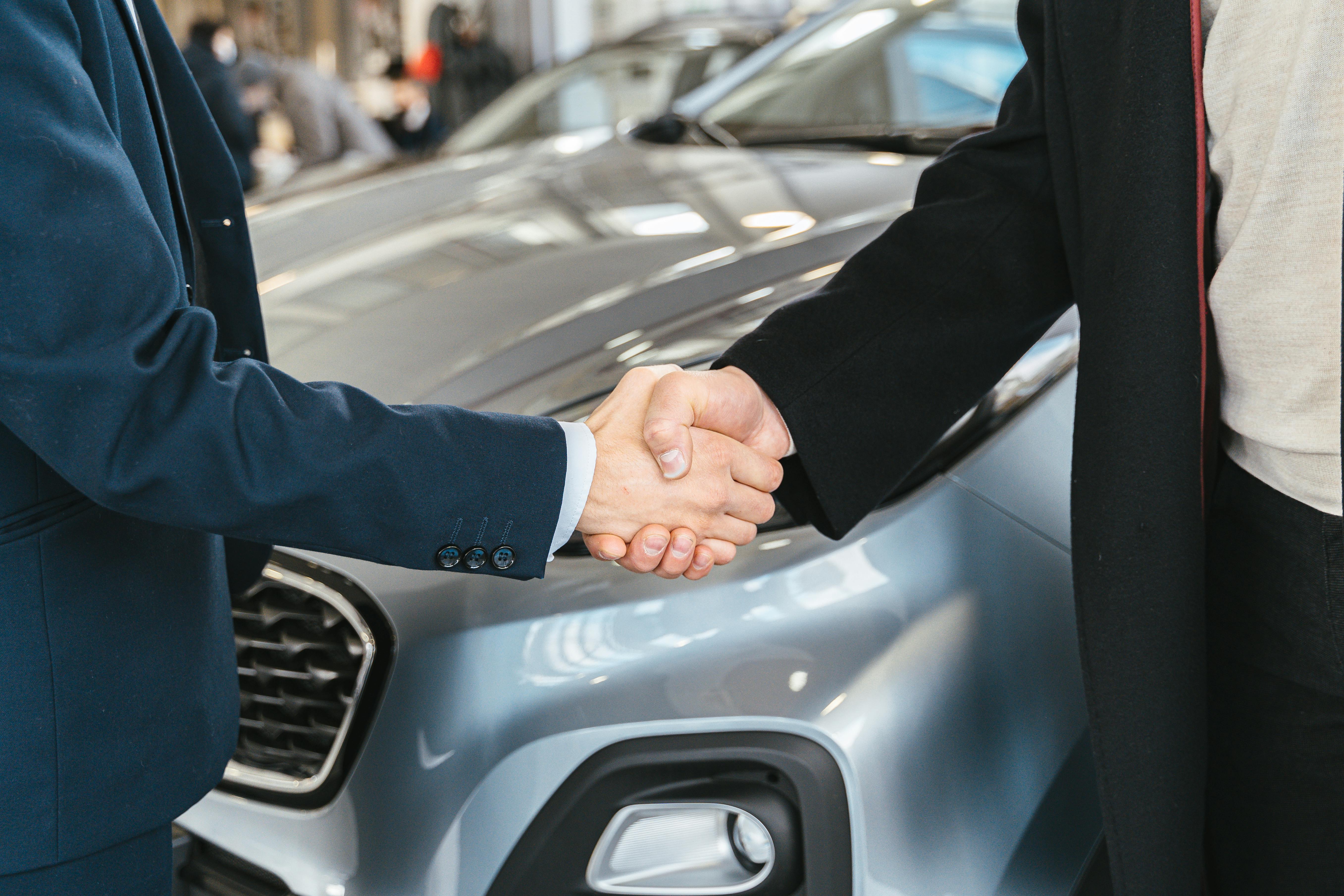 Professional business handshake representing trust in EV transactions